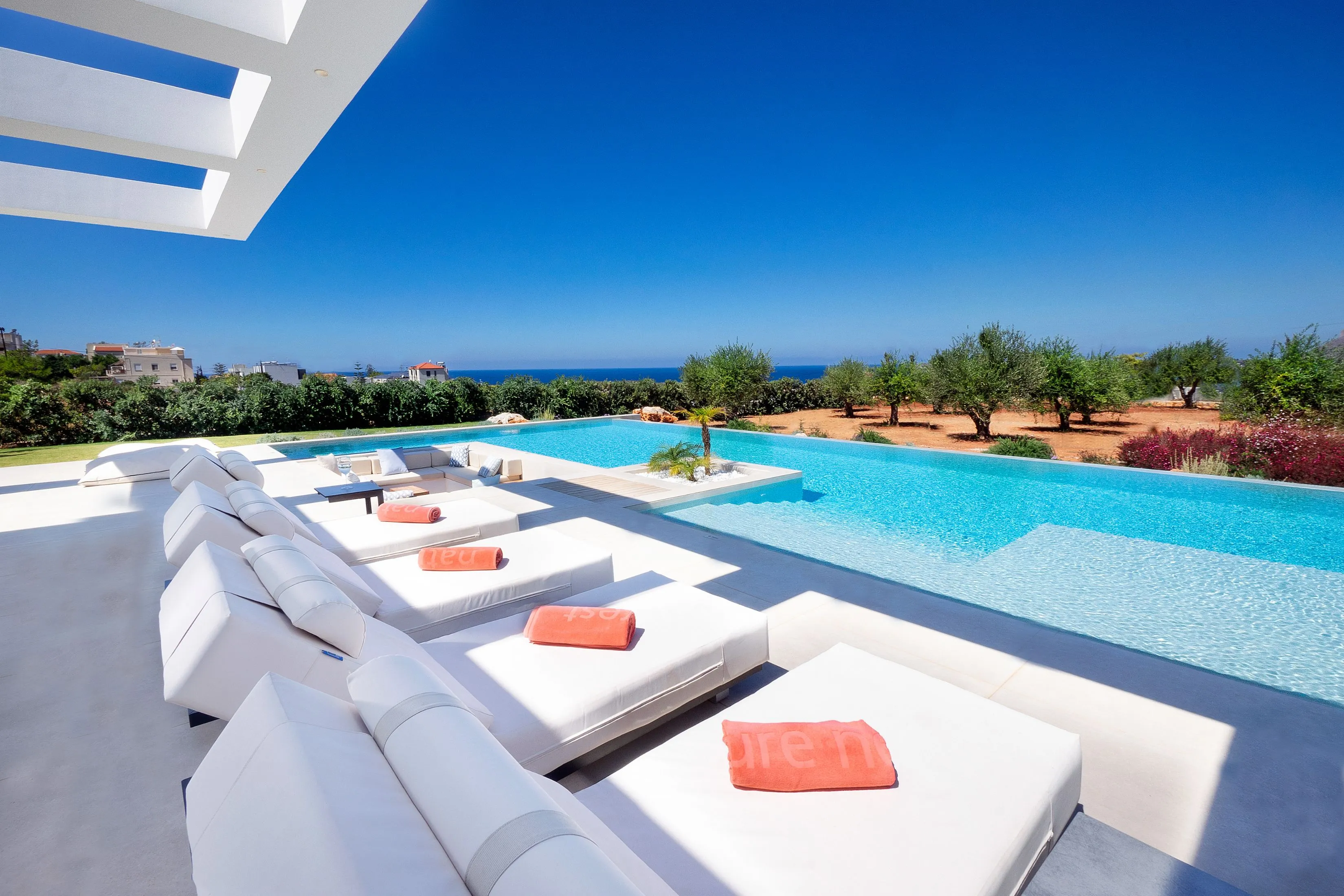 Relax on luxurious sunbeds with stunning sea views.