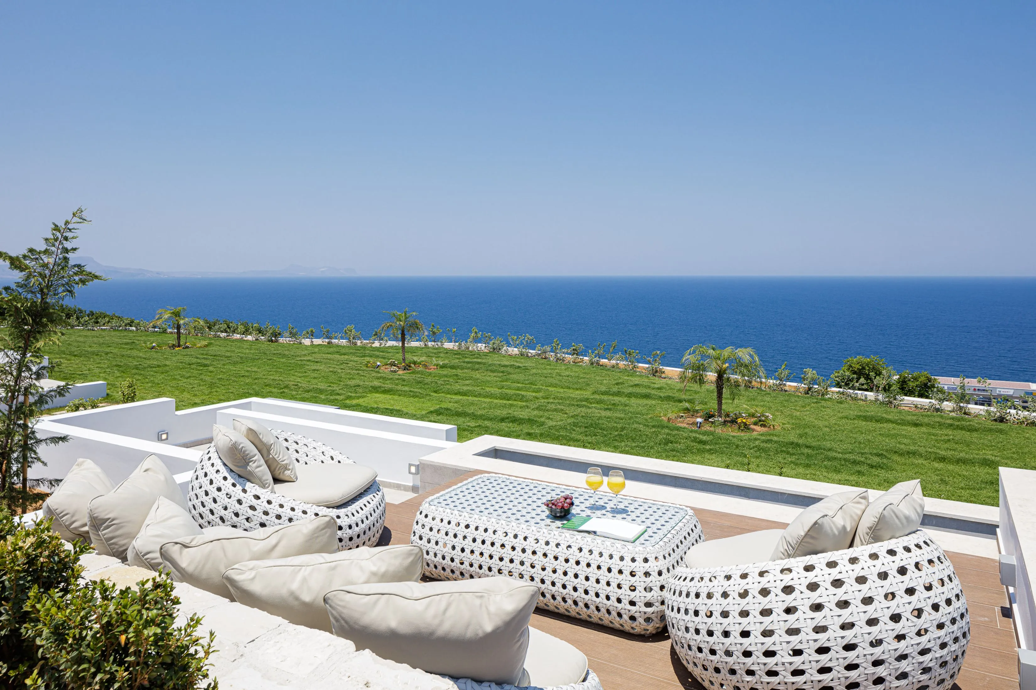 Relax by the pool with a comfortable rattan sofa and stunning views.