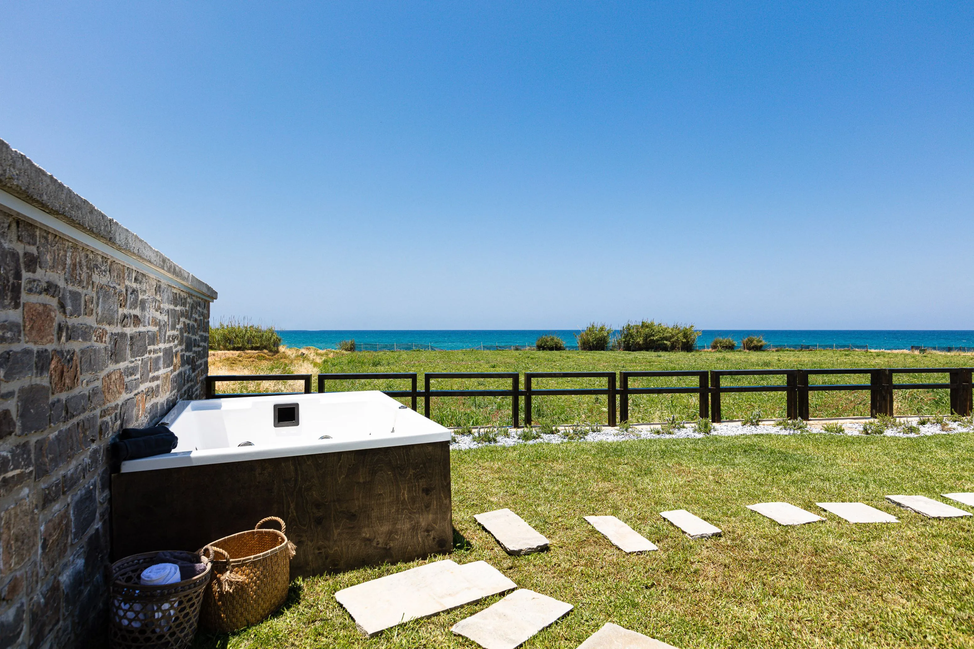 A 4 seater hot tub is also available, also enjoying the sea view!