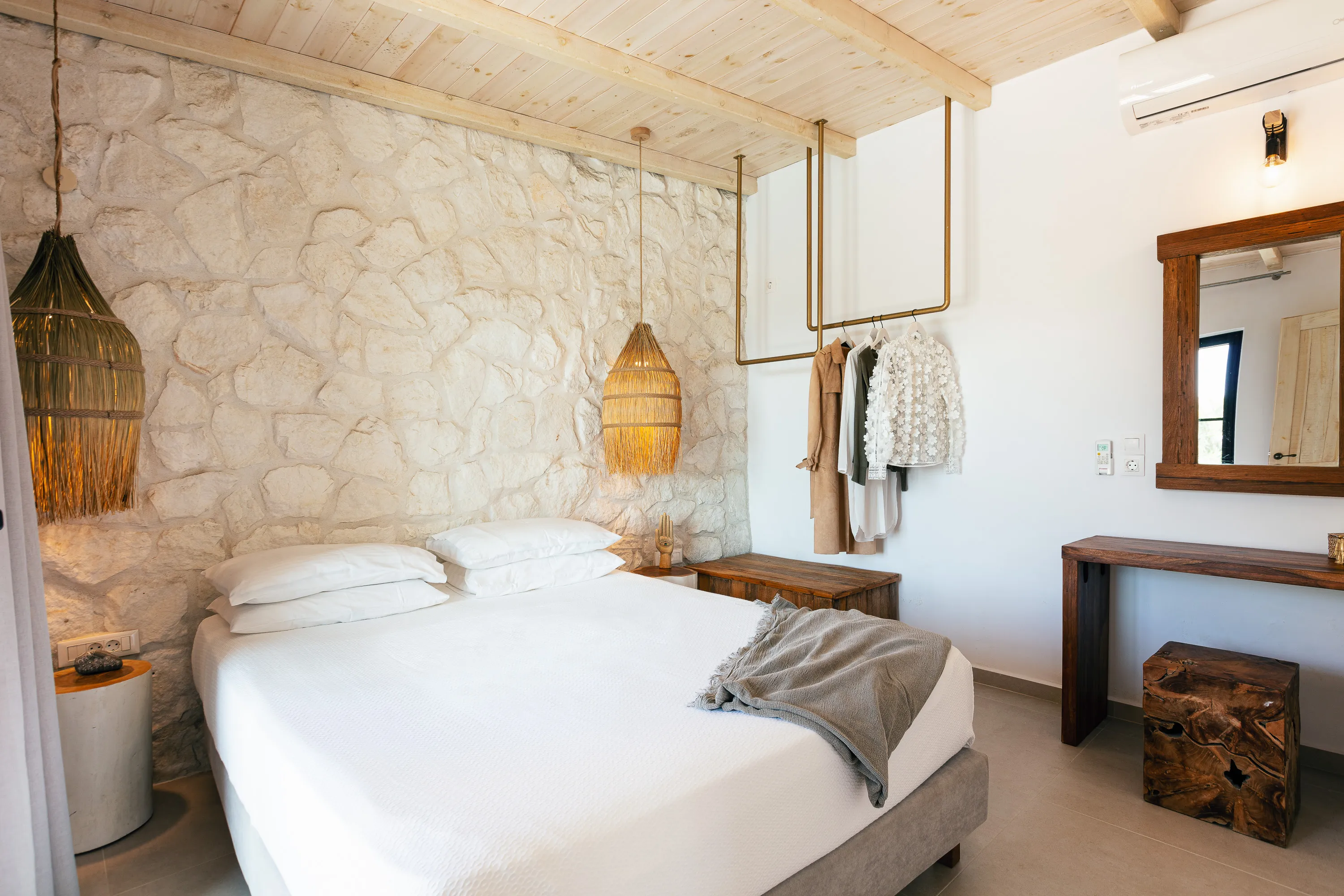 The bedroom features a double bed and has a boho chic decoration