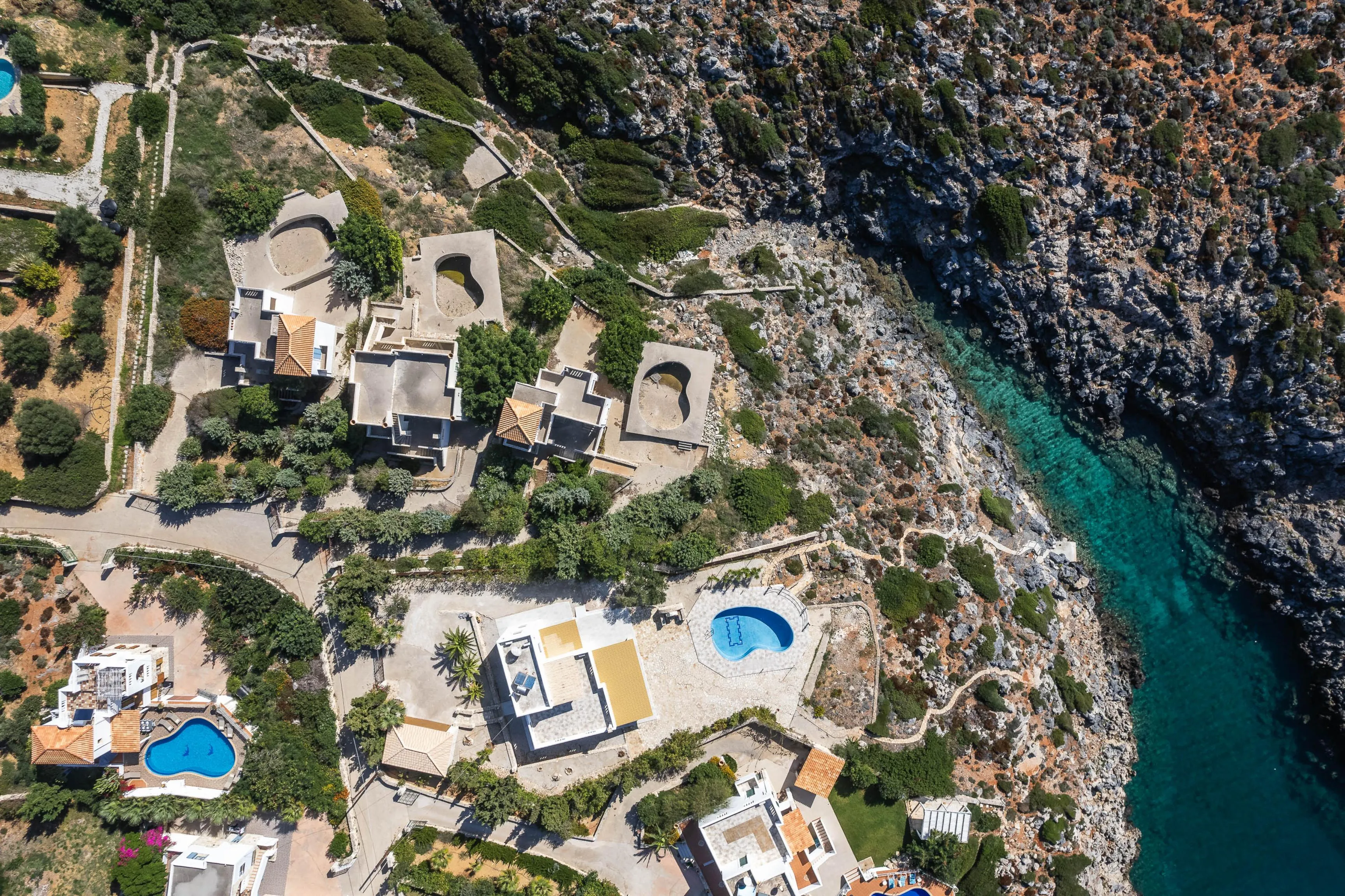 Outside the villa, there is a path that leads to a small cove (bay)