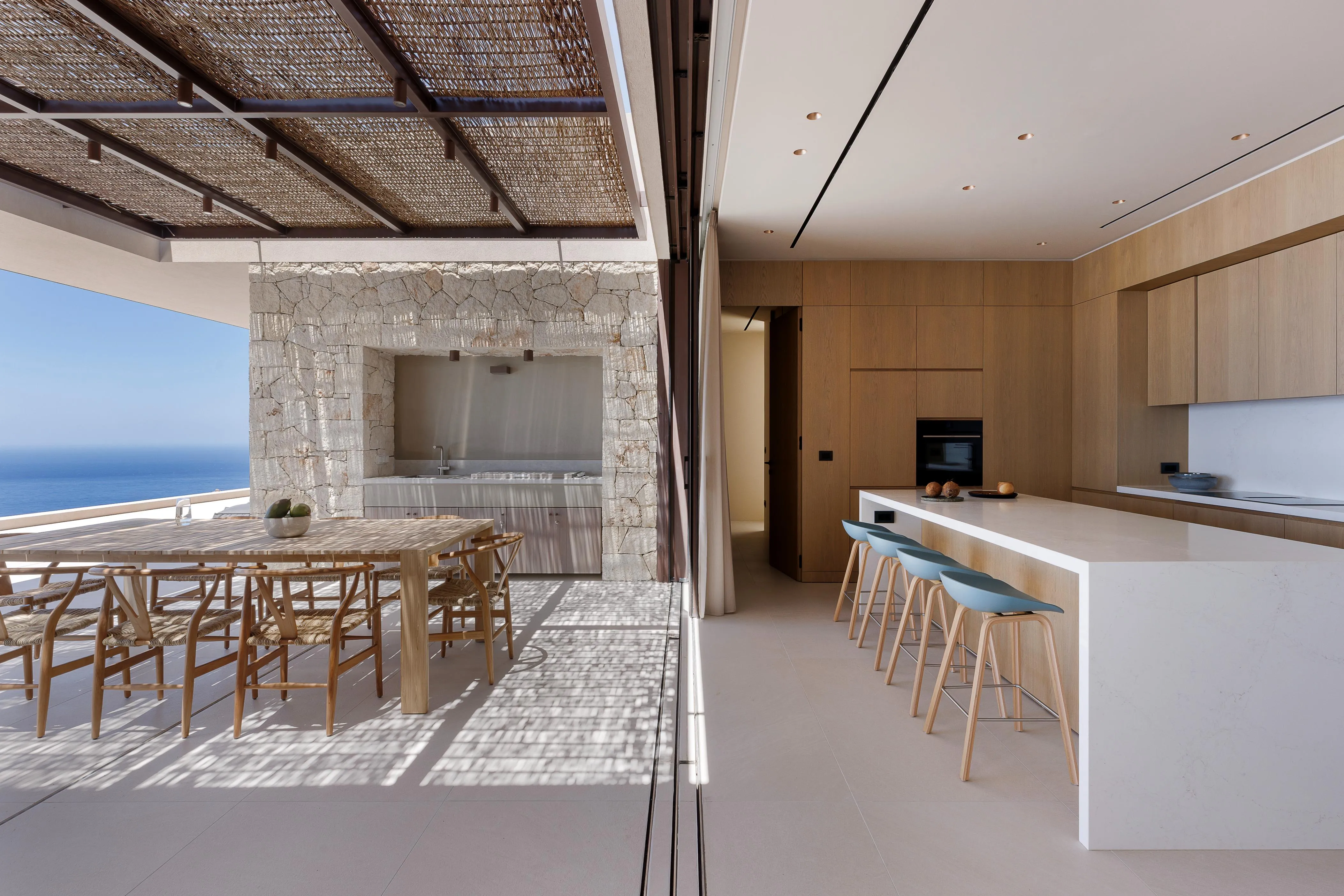 Floor-to-ceiling sliding doors disappear seamlessly into the walls, creating a stunning effect and offering a direct connection to the outdoors