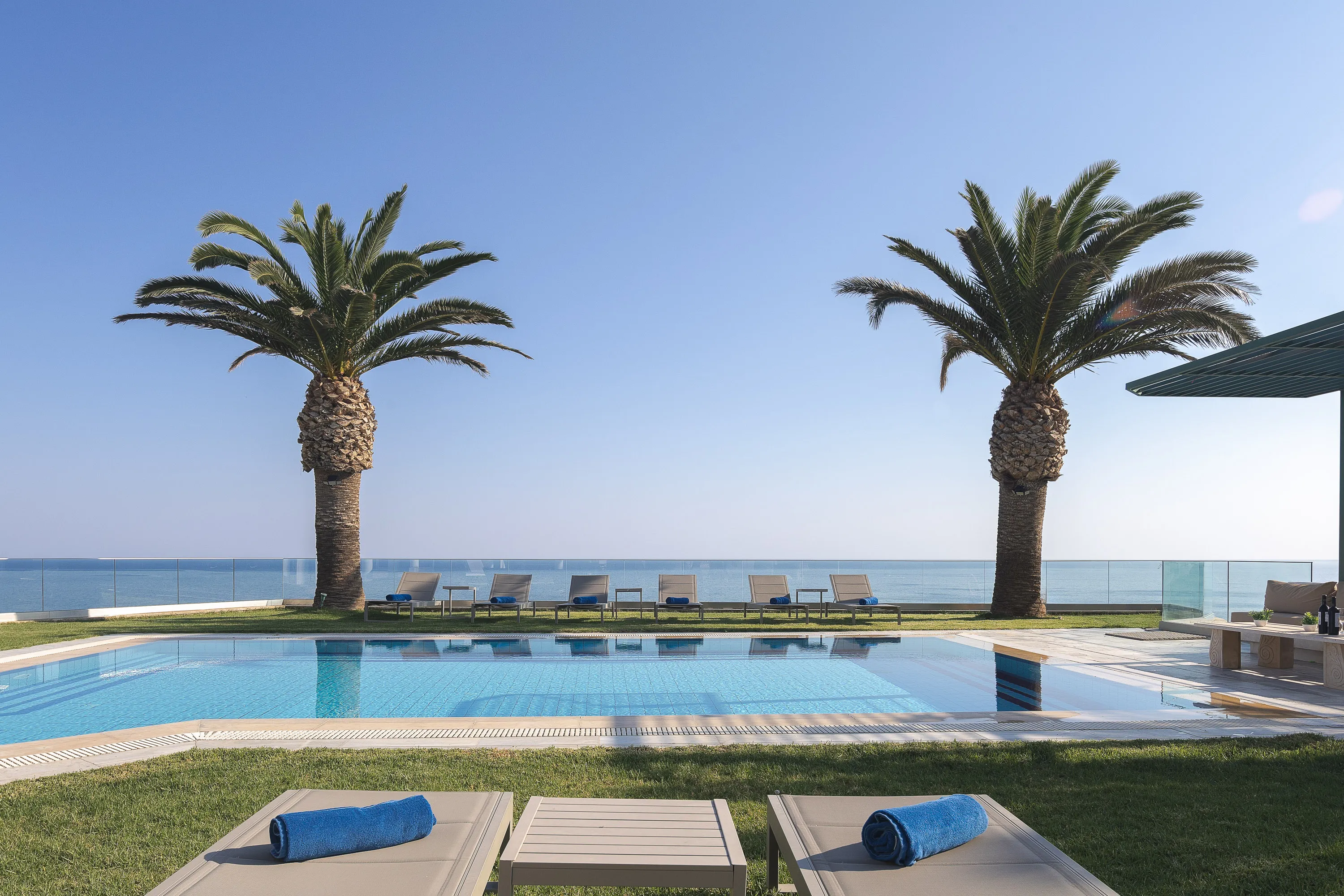 Luxury hilltop villa in Rethymno with panoramic sea views, 7 bedrooms for 14 guests, private pool, tennis court & heliport—perfect for large groups.
