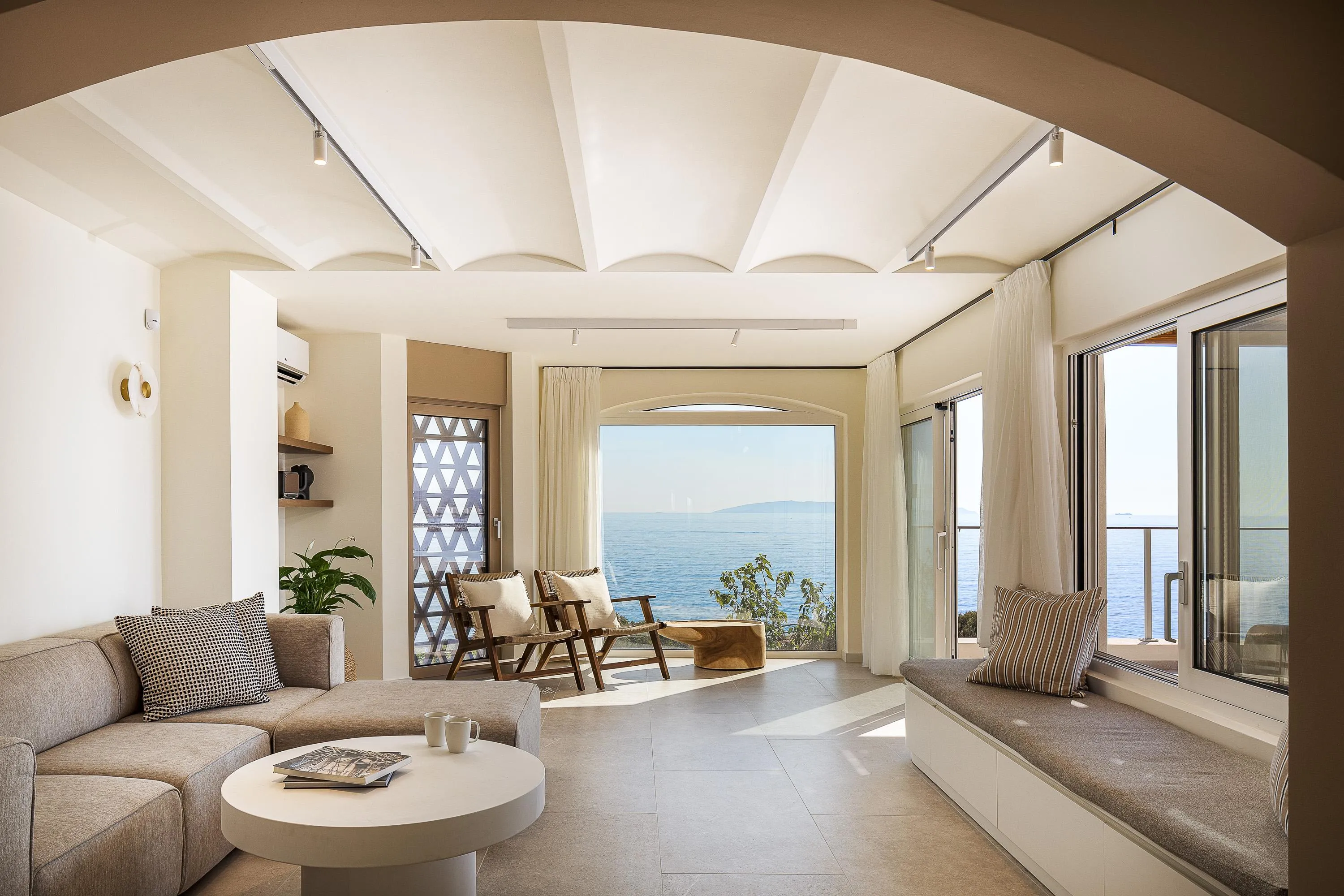 The living room offers a comfortable sofa, a fireplace, and an EDIFIER speaker