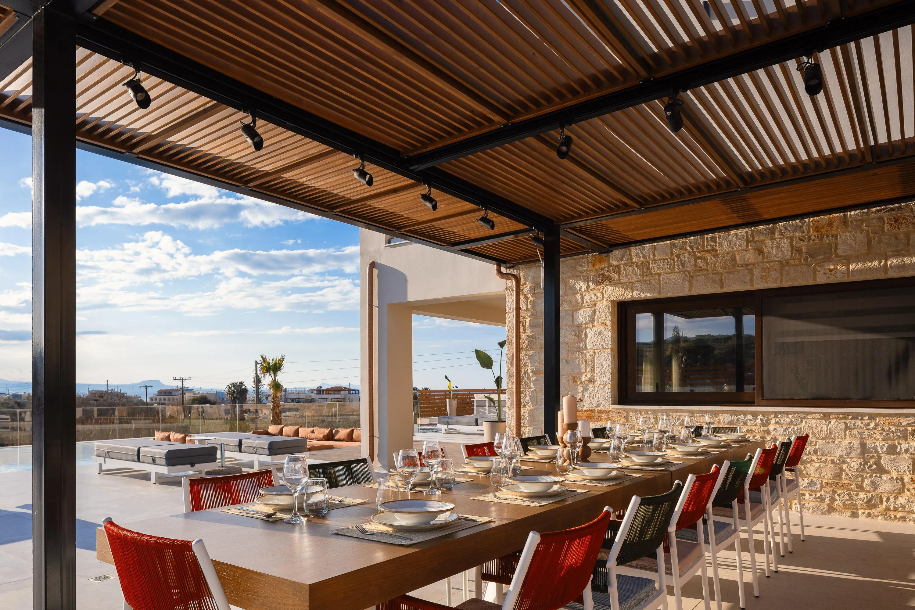Outdoor dining area for 20 guests, under a shaded pergola