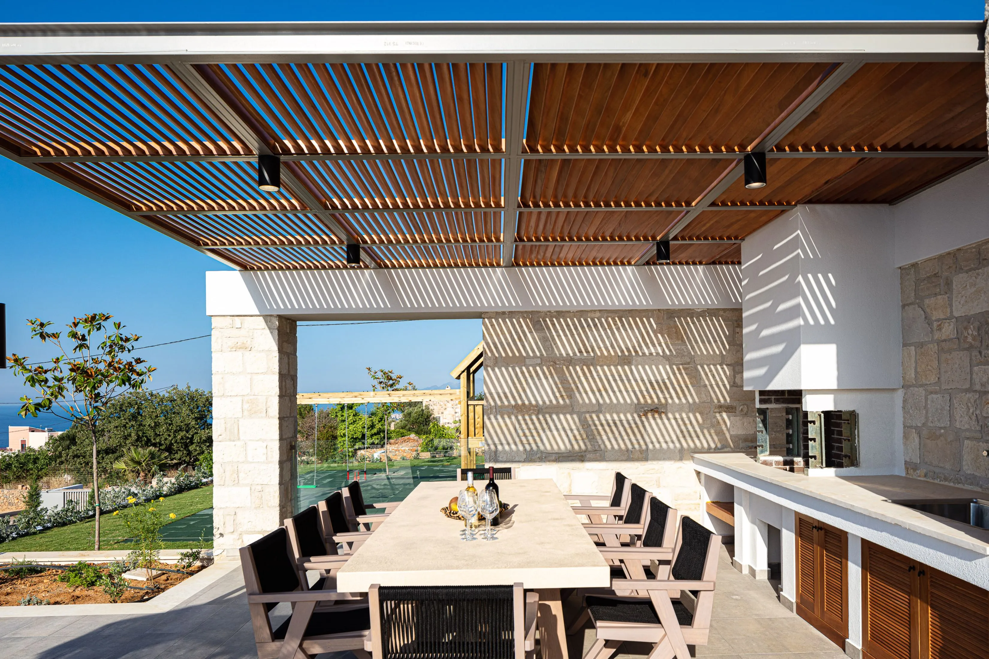 Pergola-shaded dining area perfect for al fresco meals.