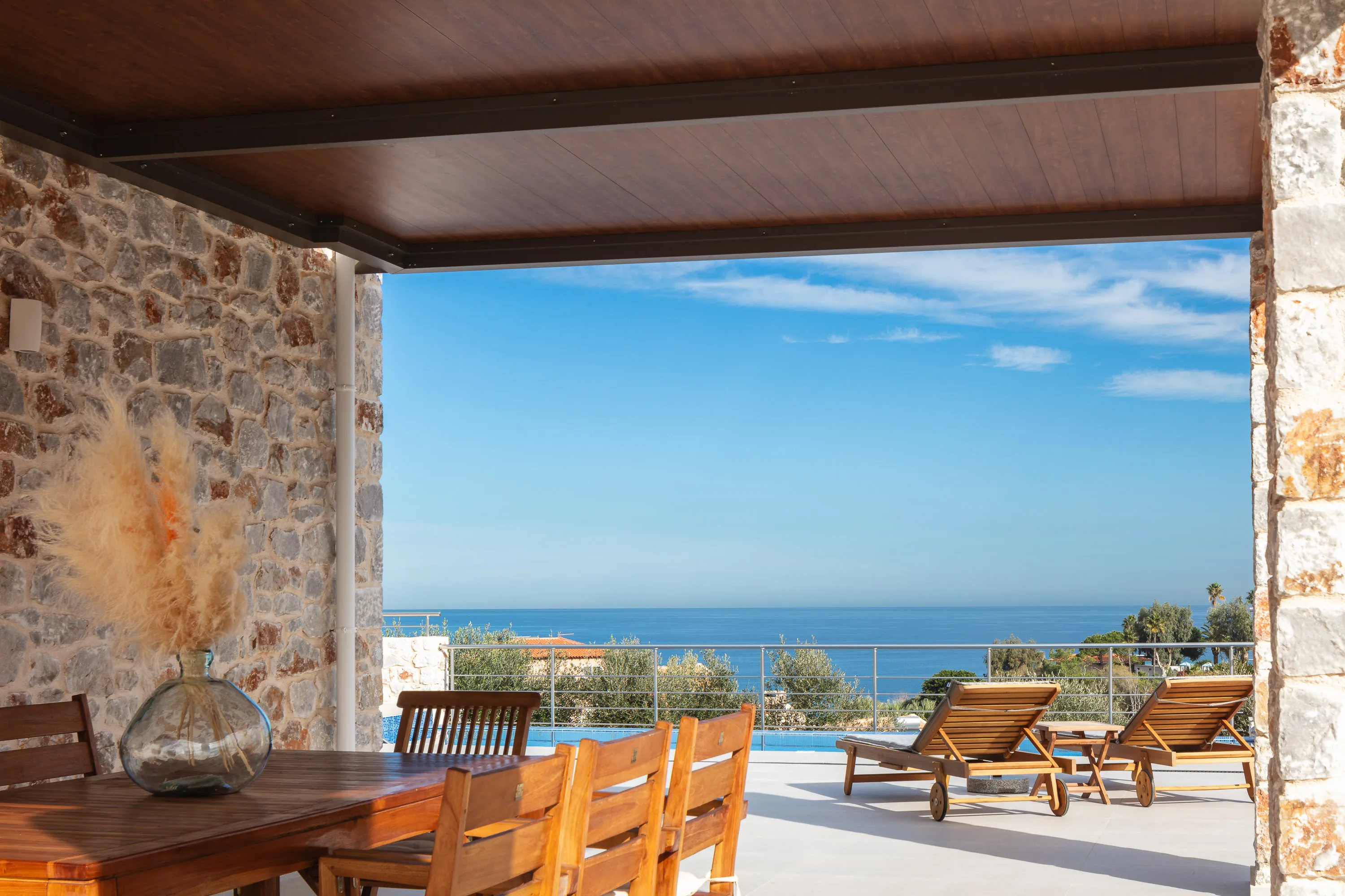 Outdoor dining area for 8 under a shaded pergola offers ample chance for al fresco dining.