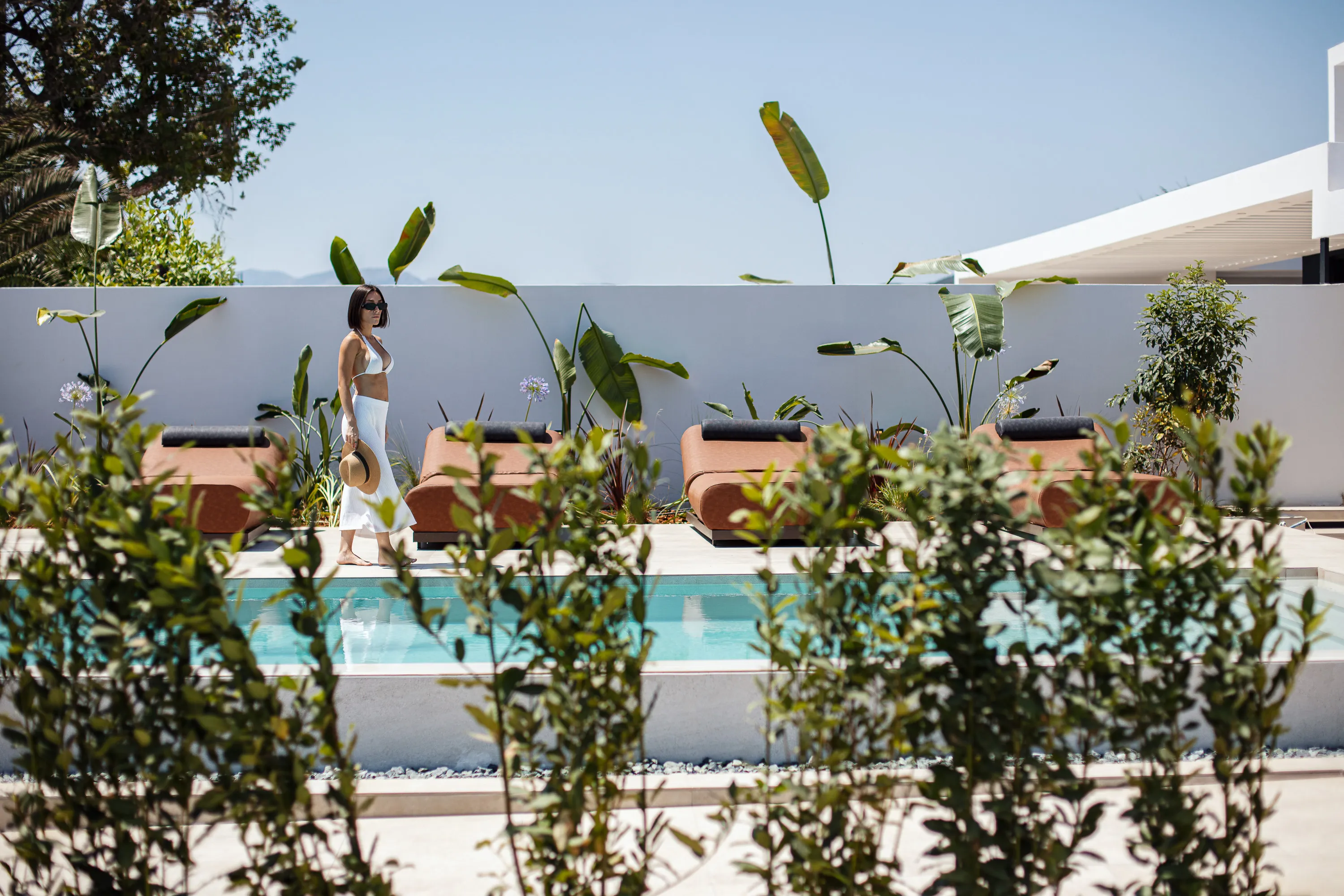 The pool area is equipped with 4 sun beds, 2 poofs and side tables
