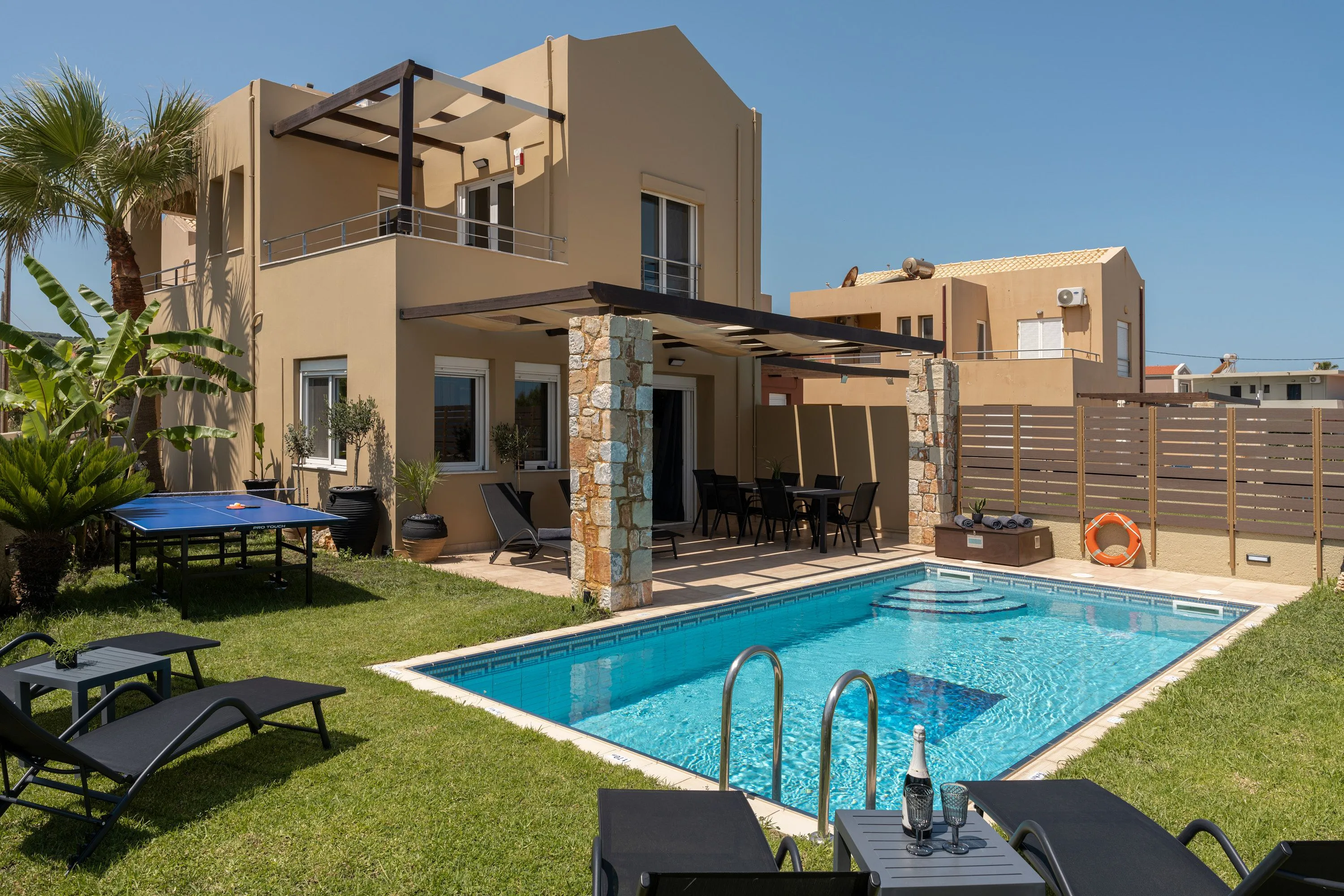 The pool area invites relaxation with six comfortable sun beds and a refreshing poolside shower.