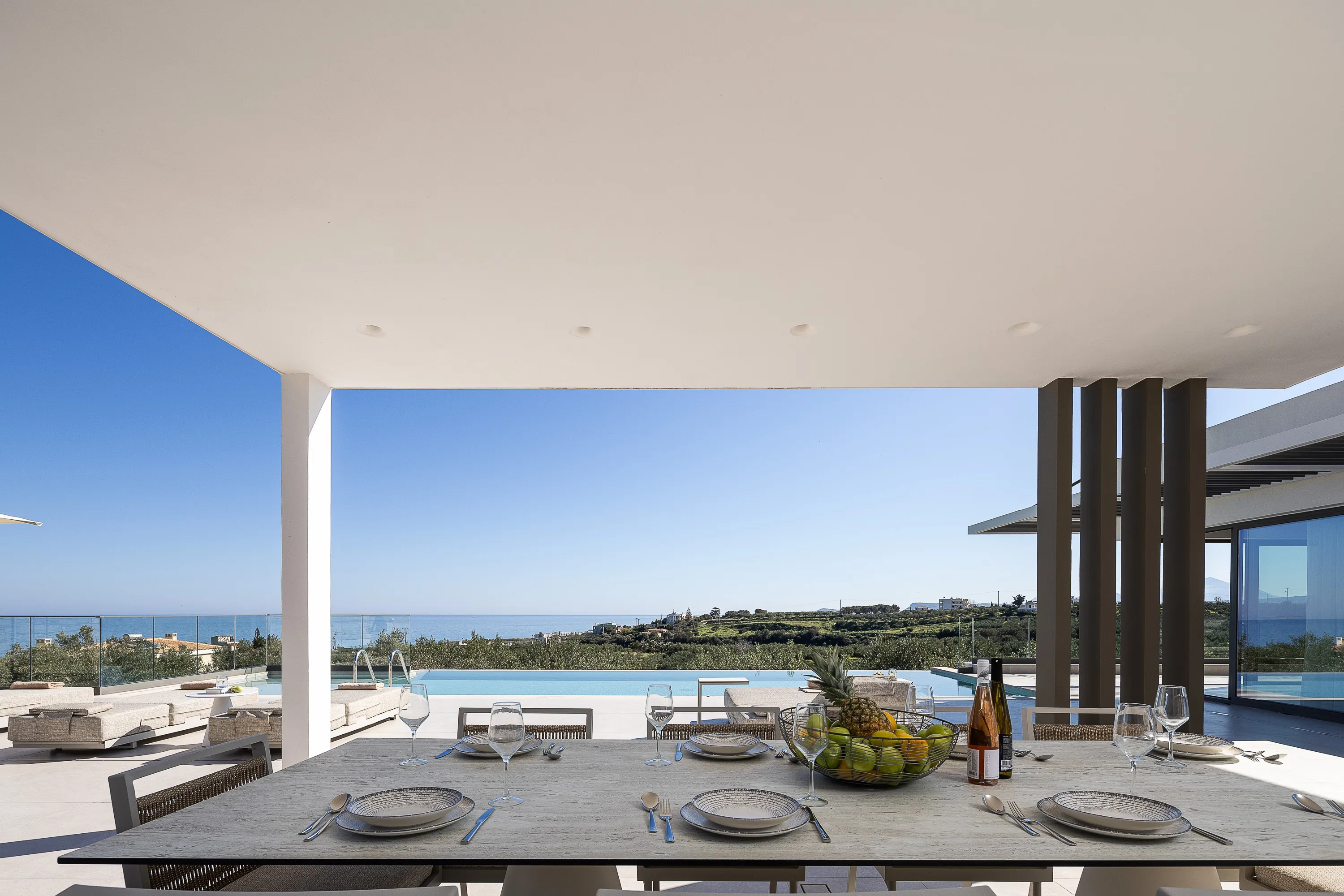 Οutdoor dining area for 10 guests under a shaded pergola