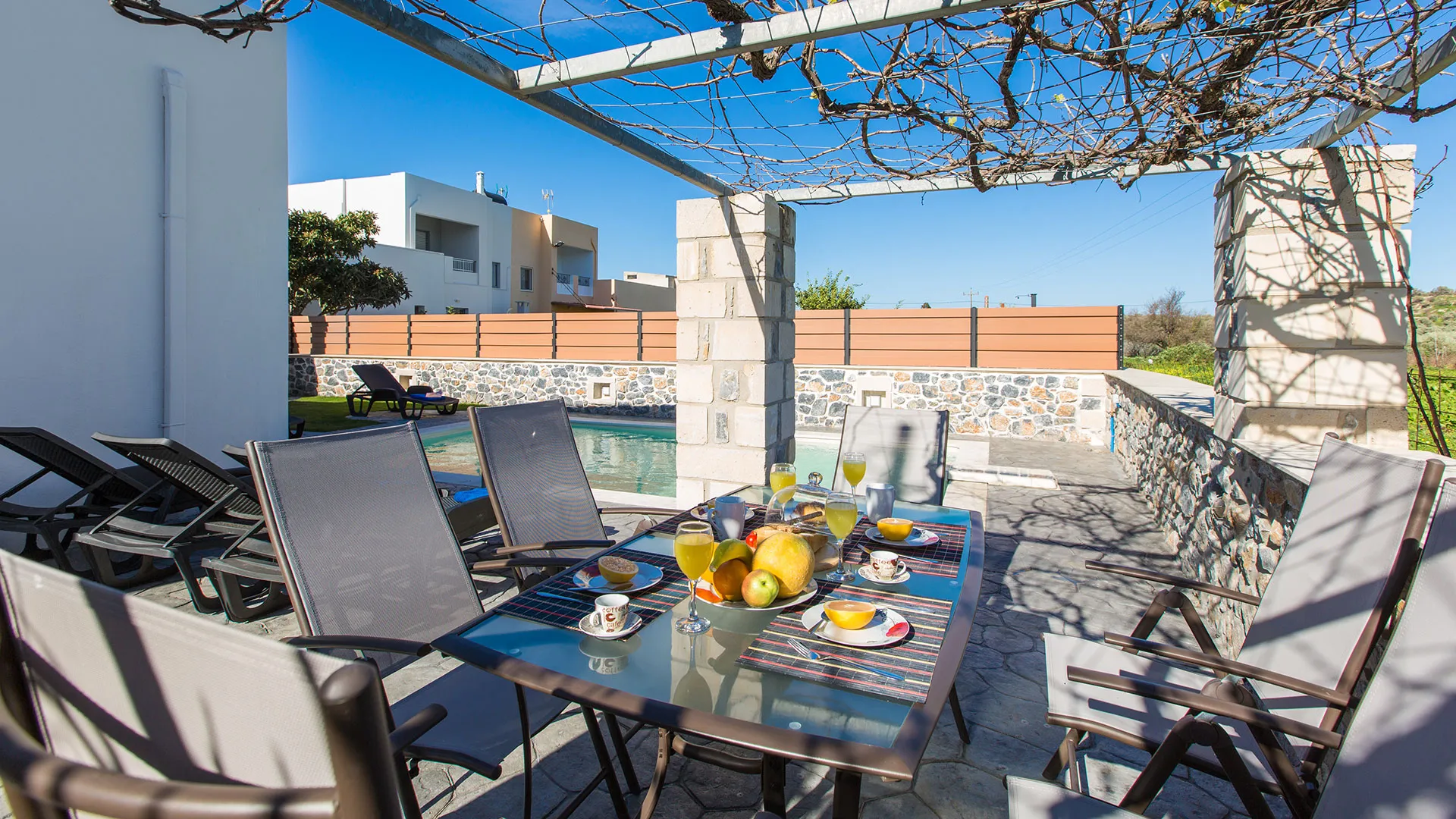 Outdoors dining area next to the swimming pool
