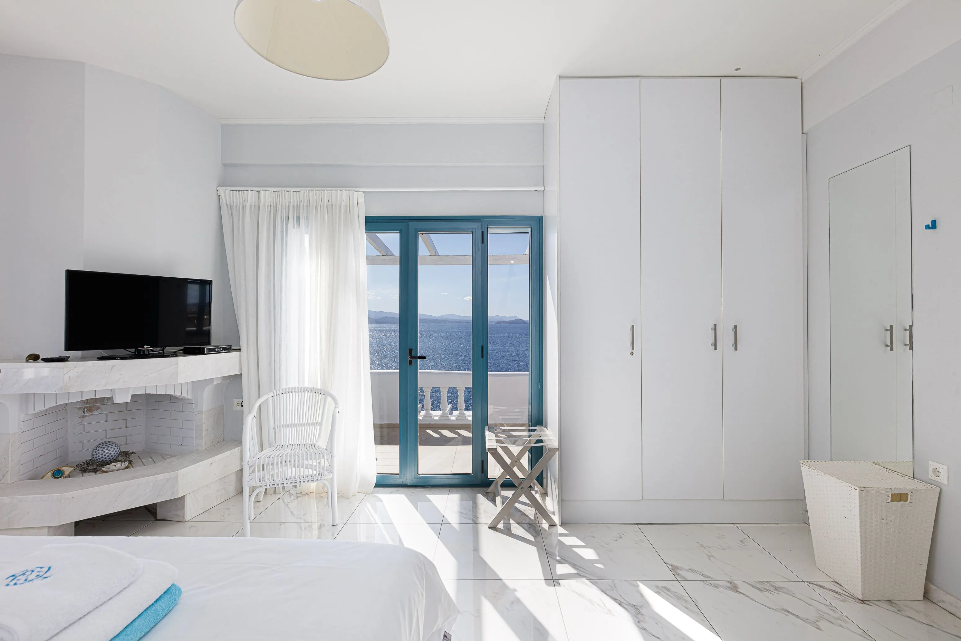 The room opens up to a private veranda with unobstructed sea views.