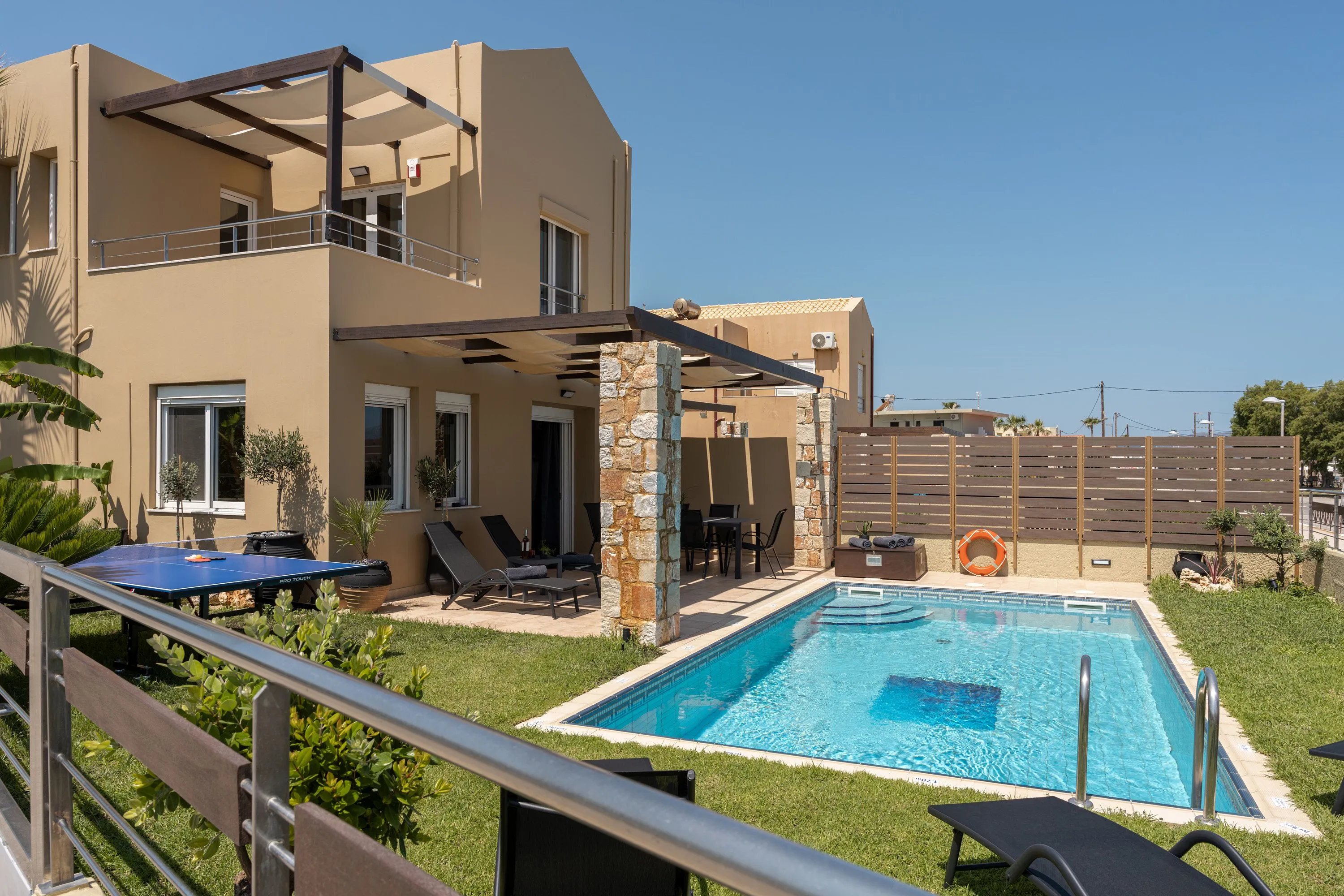 The villa is fully fenced and features a gated entrance