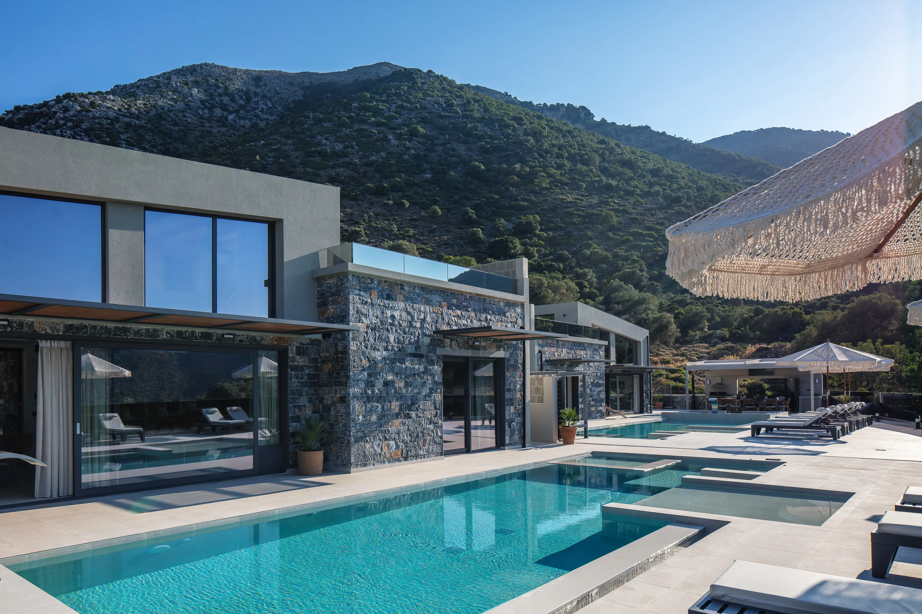 Two private, 56 sq.m. swimming pools, adorned with a graceful waterfall and two in-pool chaise longues. Each pool can be heated, for an additional daily charge upon request.