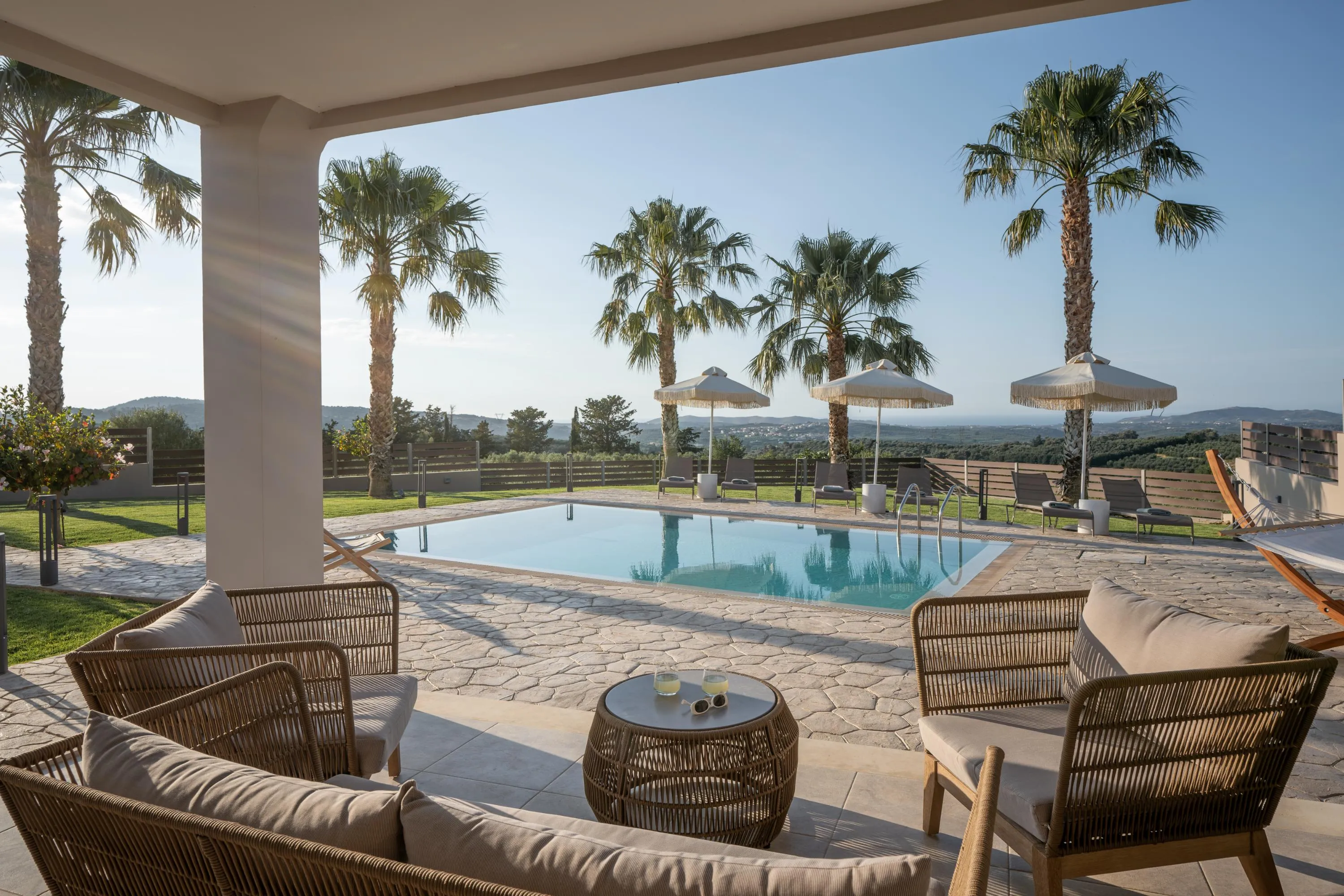 Shaded outdoor sitting area next to the pool.