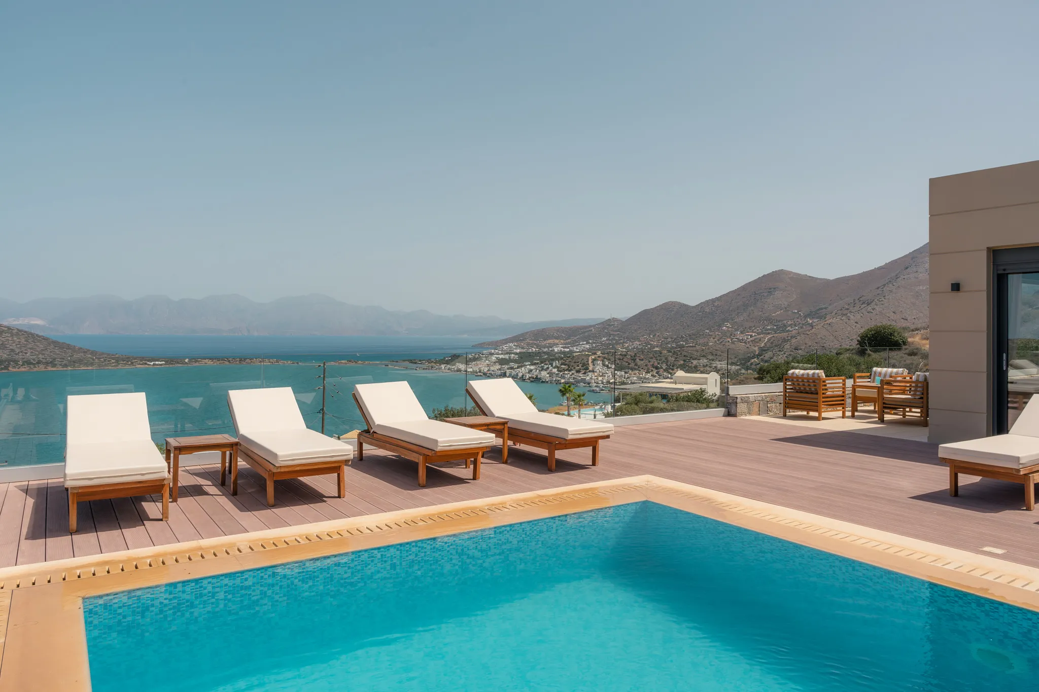 The pool area is equipped with 6 sun beds, side tables, a poolside shower, and 2 umbrellas