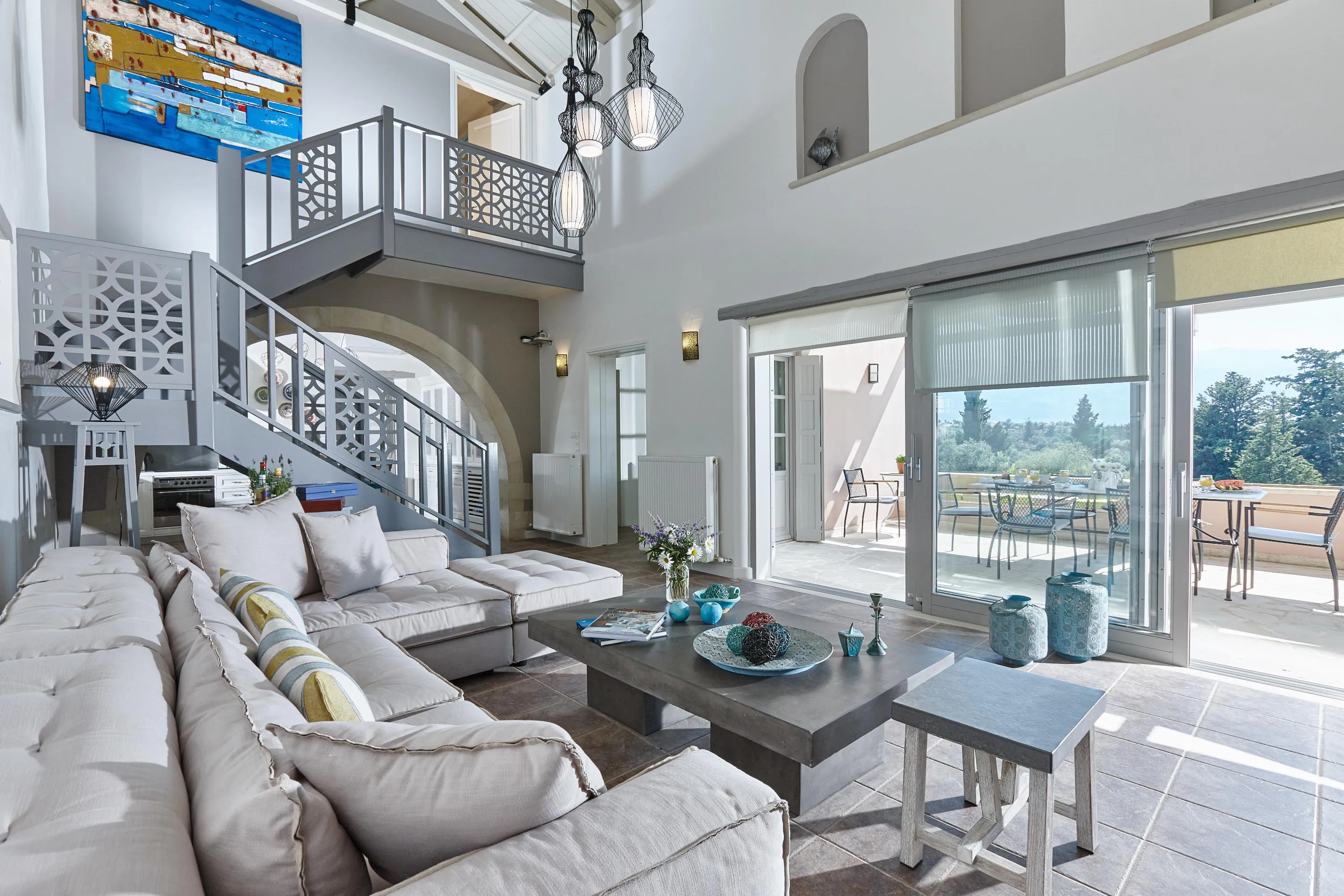The living room is perfect for relaxation, featuring a plush sofa, a 50" TV, a MARSHALL Bluetooth speaker, and a cozy fireplace for chilly evenings