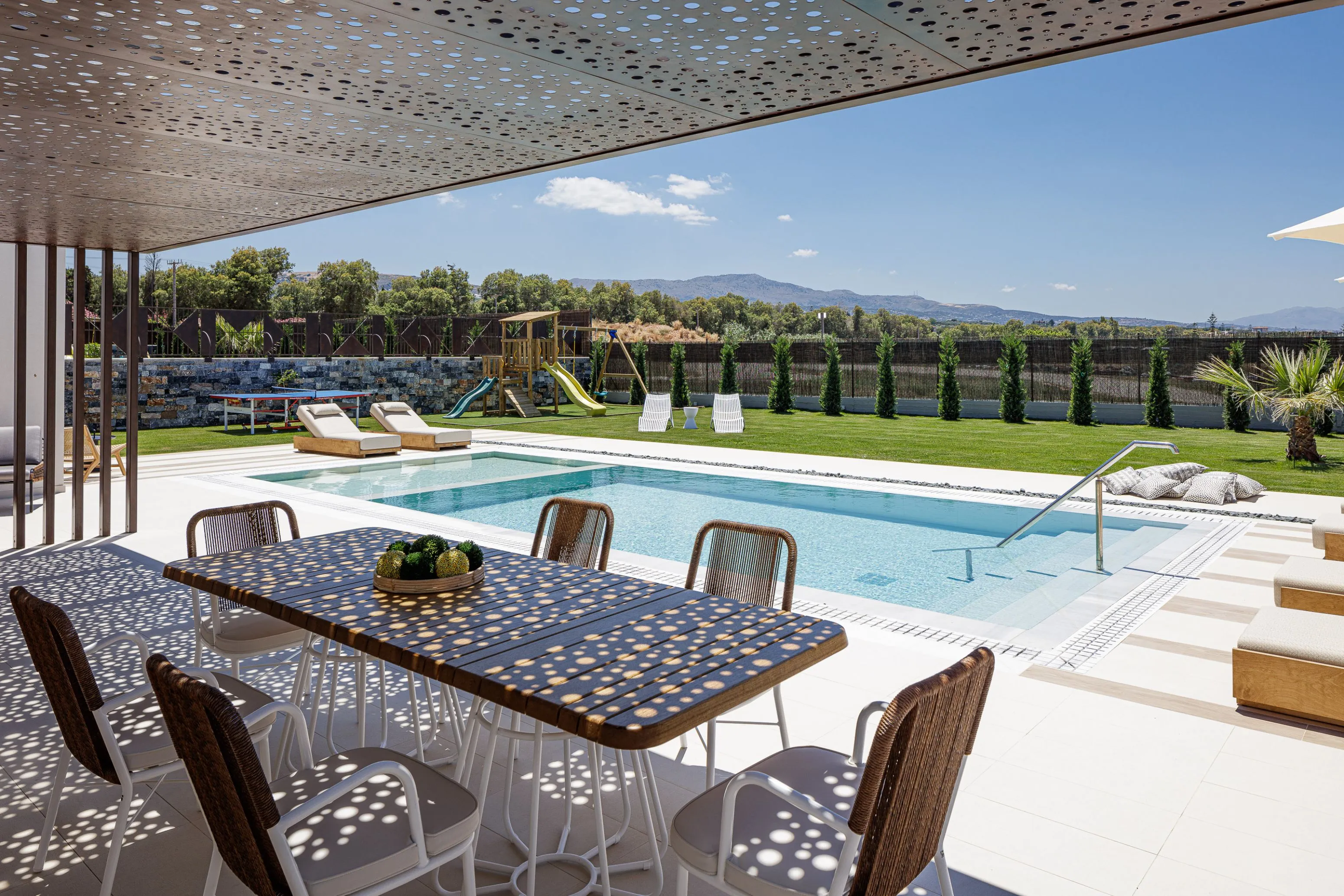 Outdoor seating and outdoor dining table under a pergola