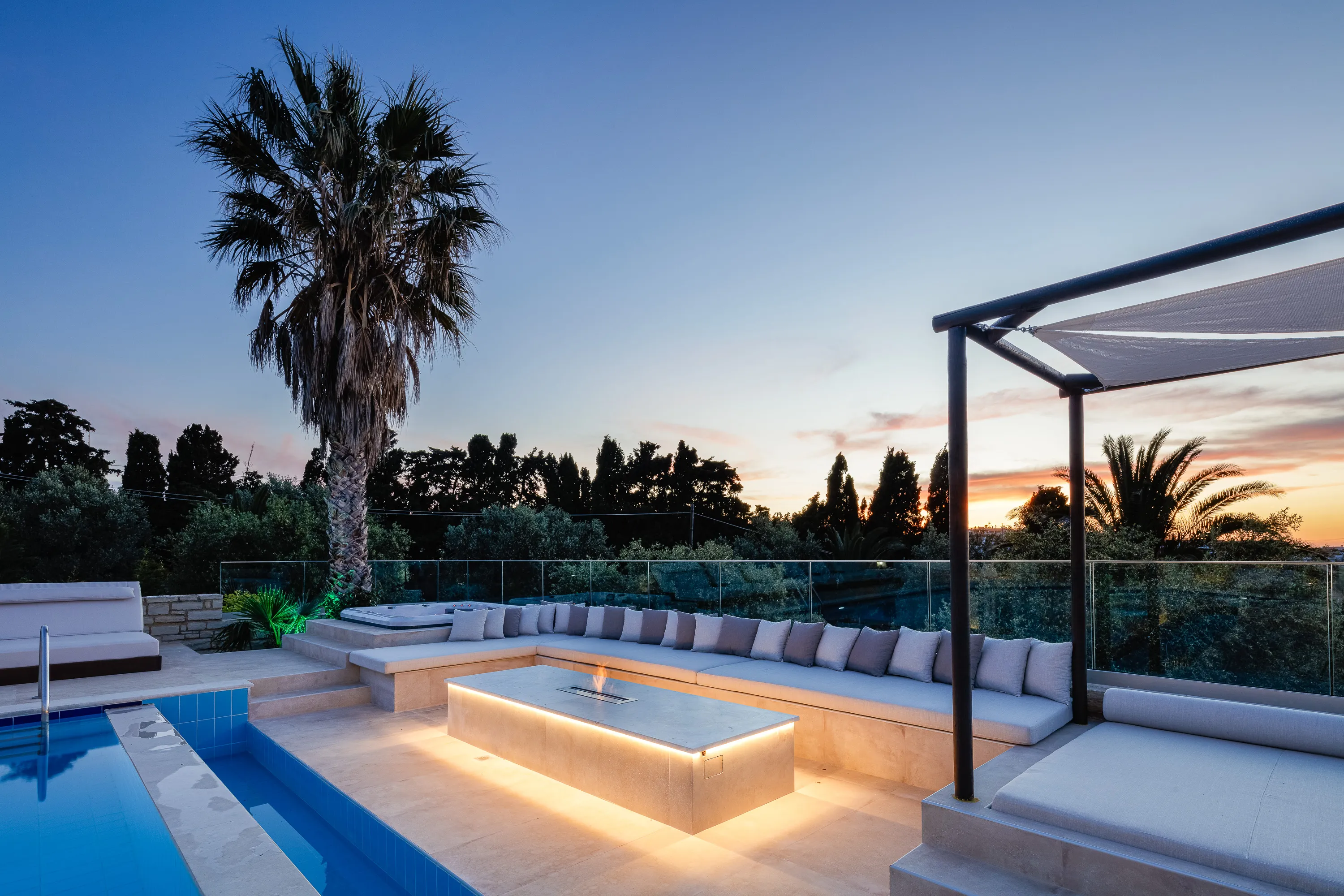 A seating area with a gas fire pit, a perfect spot for evening drinks
