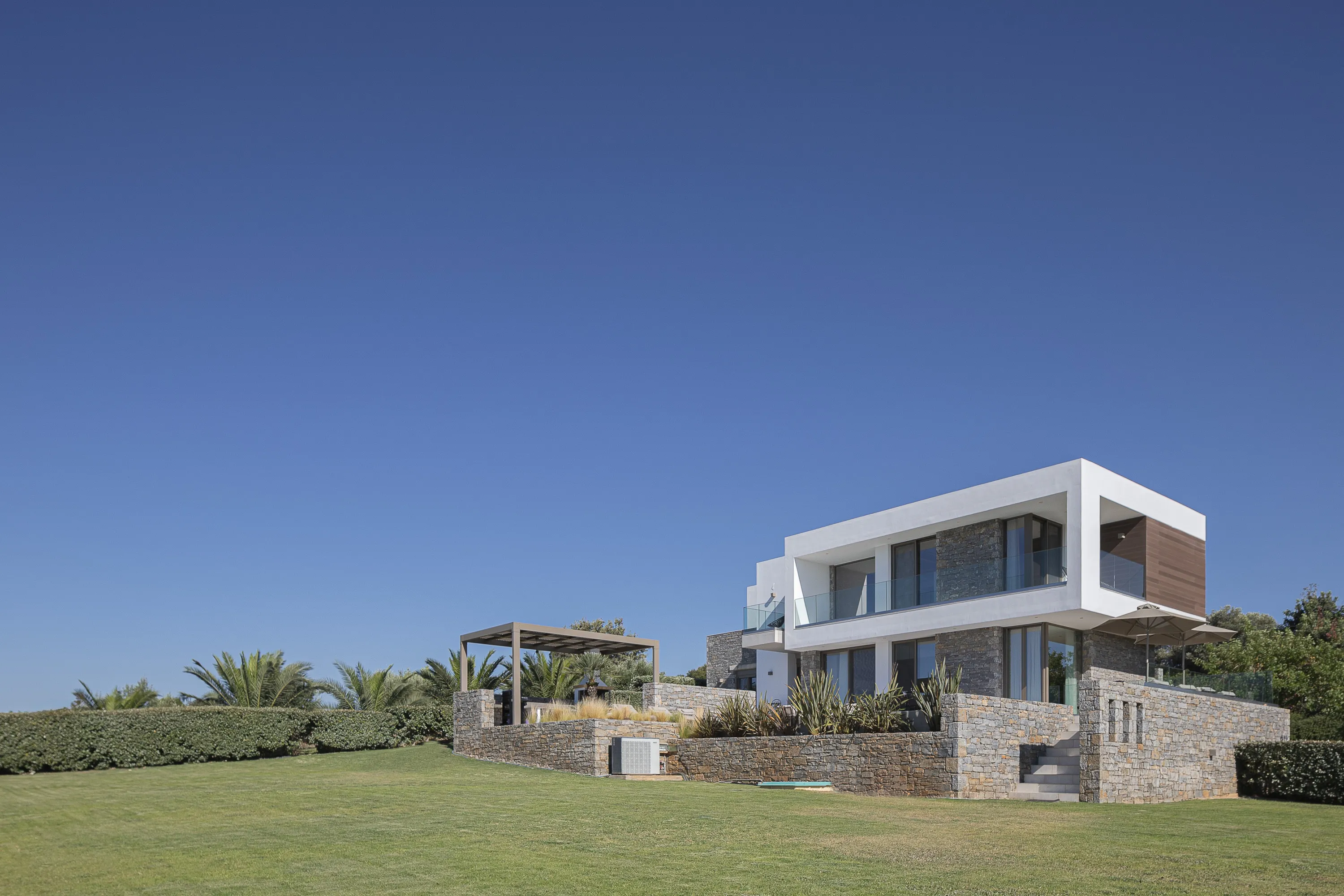 Villa Guney is surrounded by spacious grounds, manicured lawns, and a private heated pool, this contemporary four-bedroom villa comfortably accommodates up to eight guests