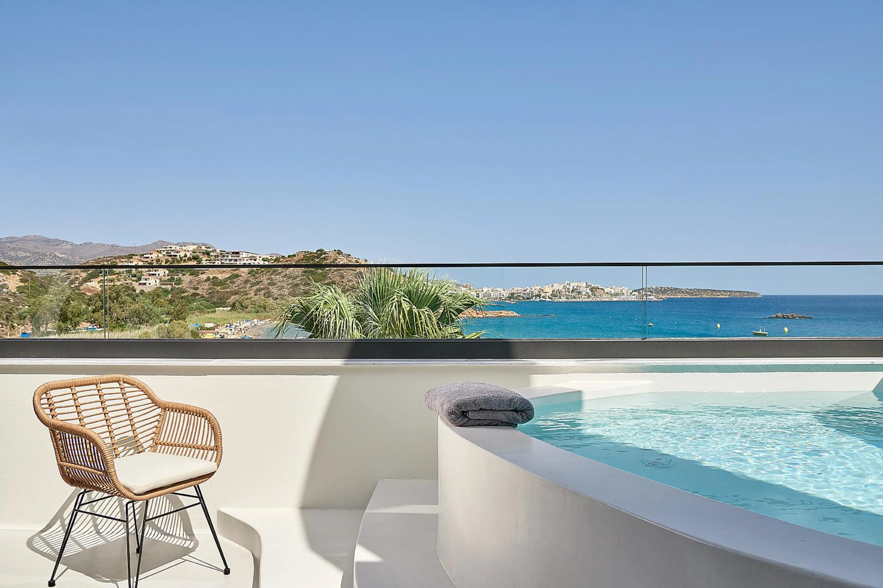 The private balcony with a mini corner pool and sitting area offers a secluded haven for relaxation.
