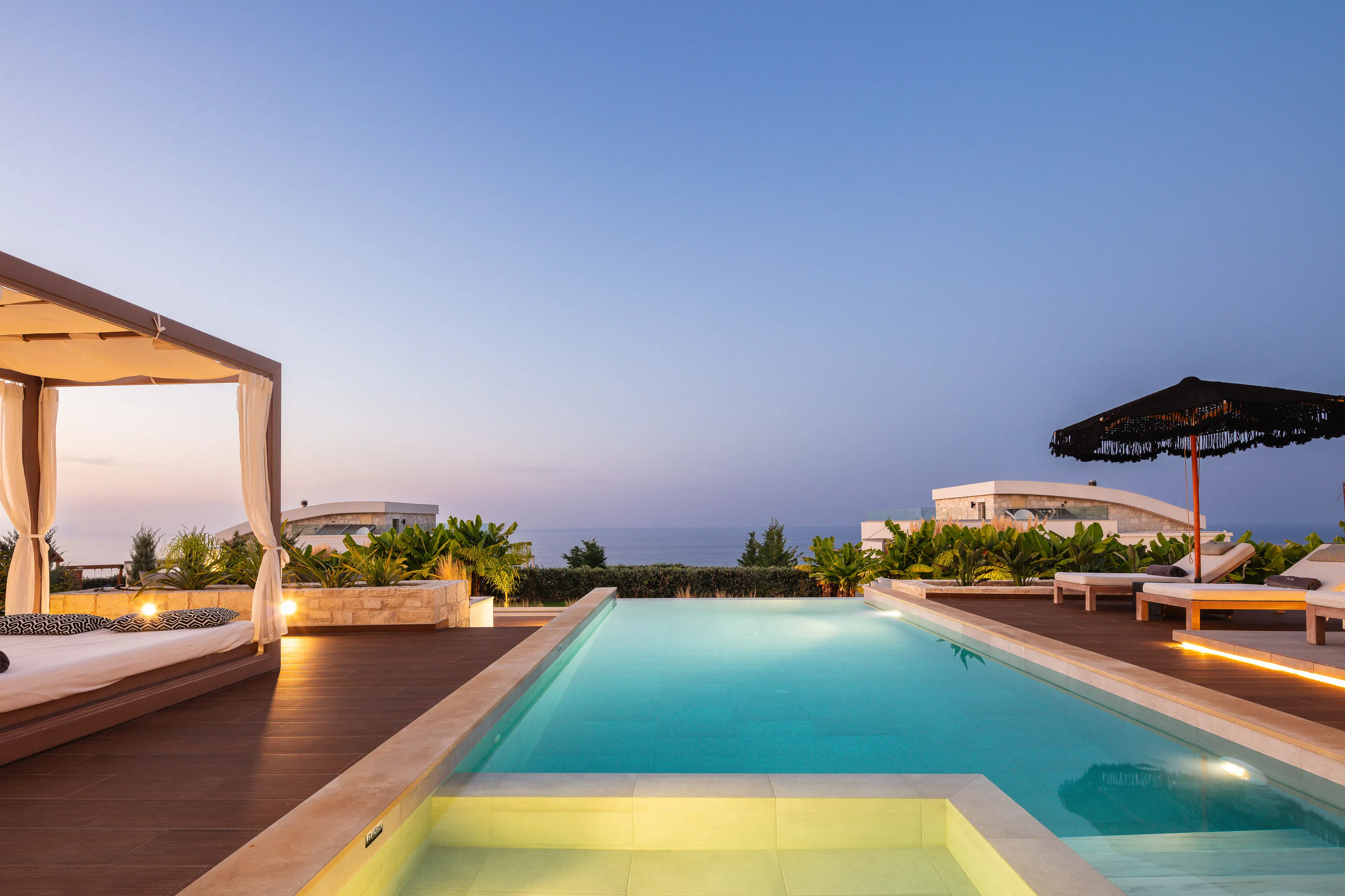A peaceful evening by the pool is the perfect way to end your day.