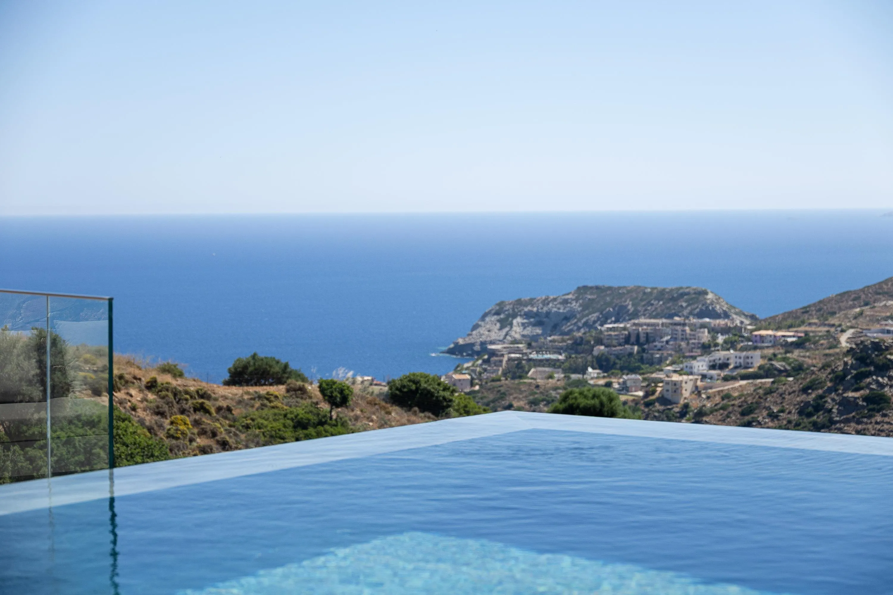 Experience outdoor luxury with a private infinity pool, sun loungers, and panoramic views of the Cretan Sea.