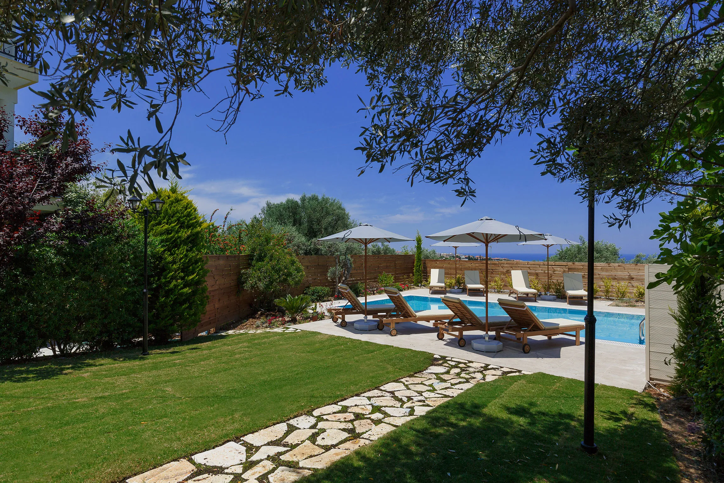 The whole outdoor area is surrounded by trees, flowers and grass