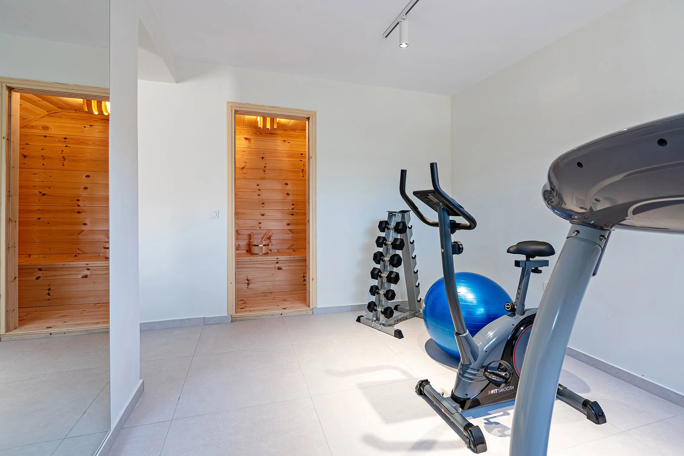 Sauna room, static bike and treadmill can be found on the lower floor.