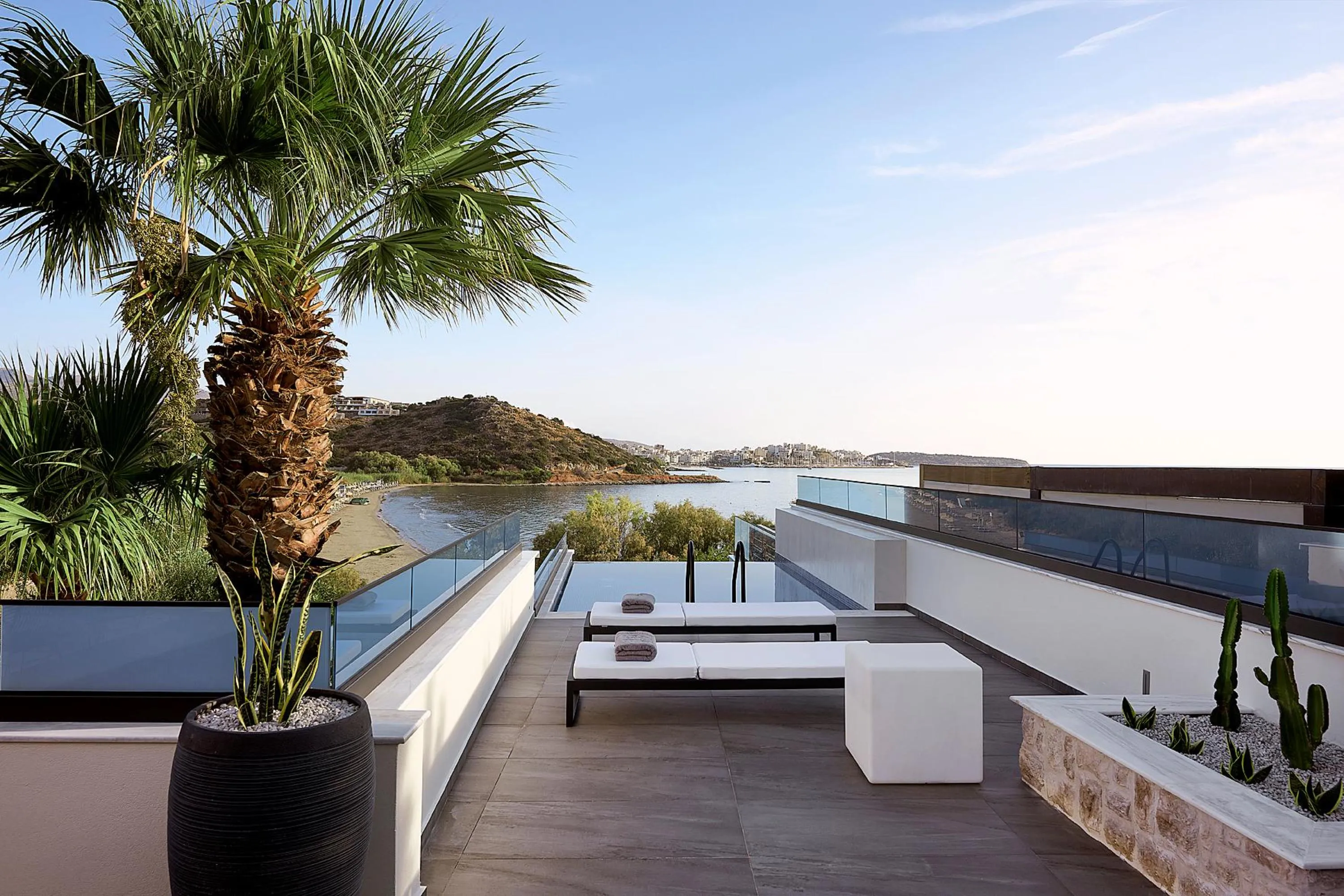 The pool area is equipped with 3 sun beds and 4 poufs